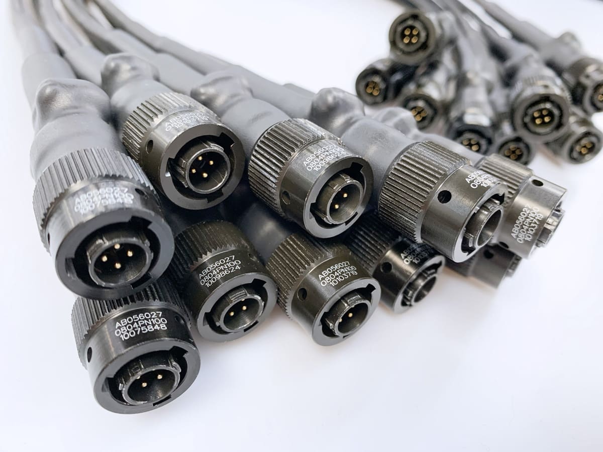 A group of military and defence grade cable assemblies. Showing the metal robust connectors.